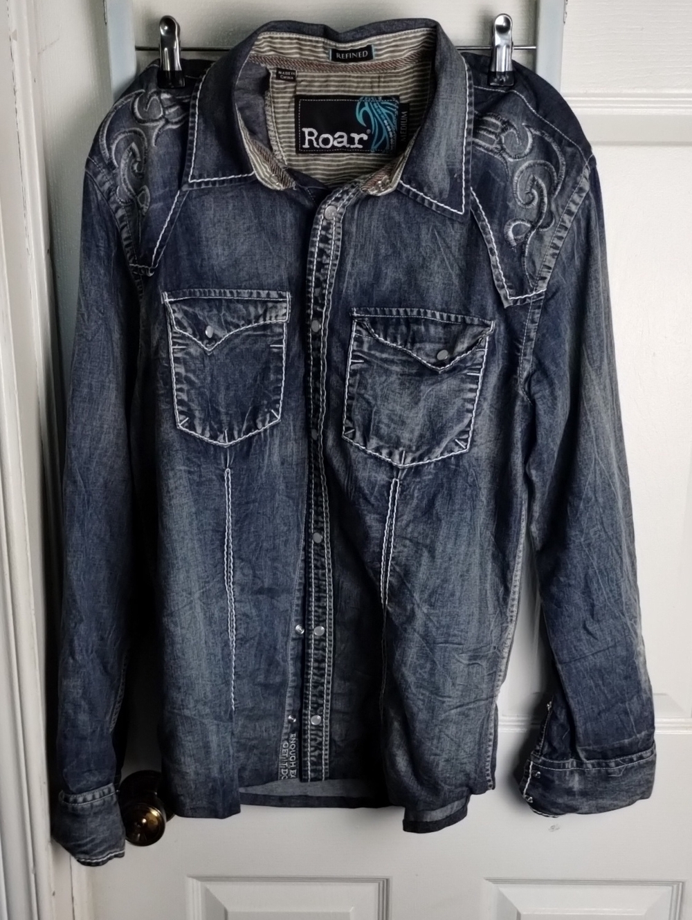 Roar Women Washed Med. Distressed Denim Shirt Jacket with Embroidered Shoulders.